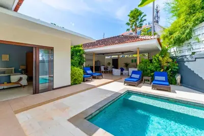 a villa with a swimming pool and a patio at Gahyaka Comfortable 2 BR Deluxe Private Pool Villa in Seminyak