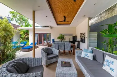 an outdoor living room with a couch and chairs at Gahyaka Comfortable 2 BR Deluxe Private Pool Villa in Seminyak