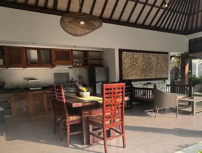 a kitchen and dining room with a table and chairs at Alex Villa Bali in Seminyak