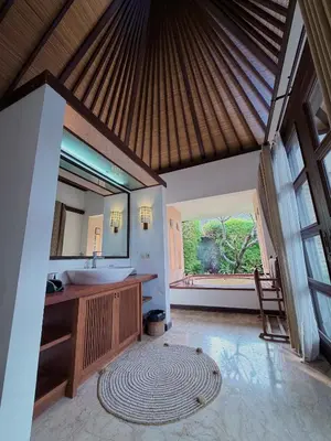 a bathroom with a sink and a large mirror at Alex Villa Bali in Seminyak
