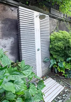 a small wooden door in a garden with plants at Alex Villa Bali in Seminyak