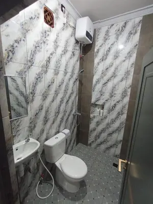 a bathroom with a toilet and a sink at Tirta Suci Guest House in Ngurah Rai International Airport
