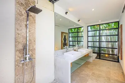 a bathroom with two sinks and a shower at Zen Retreat 3BR Japanese Inspired Oasis with Pool in Canggu
