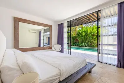 a bedroom with a large bed and a large mirror at Zen Retreat 3BR Japanese Inspired Oasis with Pool in Canggu