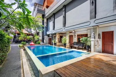 a swimming pool in the backyard of a house at Collection O Dukuh Segara Guest House in Balian