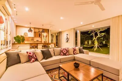 a living room with a couch and a table at Kalyca Stunning 5 BR Private Pool Villa in Jimbaran