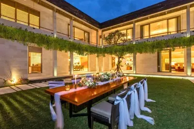 a long table in the backyard of a house at Kalyca Stunning 5 BR Private Pool Villa in Jimbaran