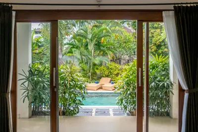 a view of a pool from a room with sliding glass doors at Villa Melbourne in Seminyak