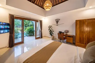 a bedroom with a bed and a desk at Villa Melbourne in Seminyak