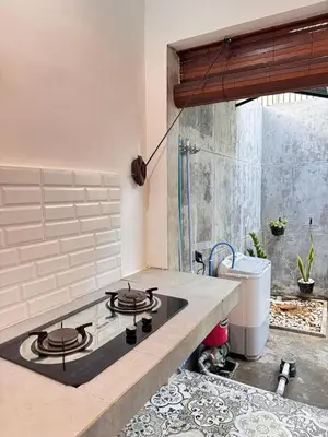 a kitchen with a stove top oven in a kitchen at Cozy Minimalist Home Near Seminyak & Kuta in Seminyak