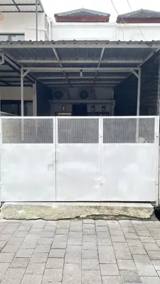 a pair of white garage doors on a building at Cozy Minimalist Home Near Seminyak & Kuta in Seminyak
