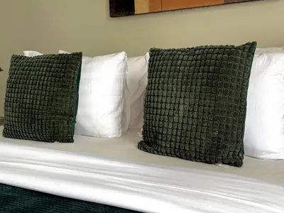 two green and white pillows on a bed at Jalina Private Villa in Central Seminyak in Seminyak