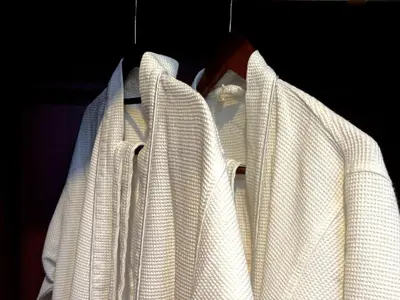 a group of white jackets hanging on a rack at Jalina Private Villa in Central Seminyak in Seminyak