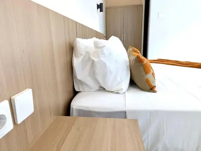a room with a bed with a pillow and a table at Brand new central Villa in Canggu