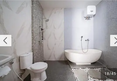 a bathroom with a tub and a toilet and a sink at Angeliq Villa Nusa Dua Bali in Nusa Dua