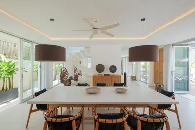 a dining room with a table and chairs at Villa Turkuaz in Seminyak