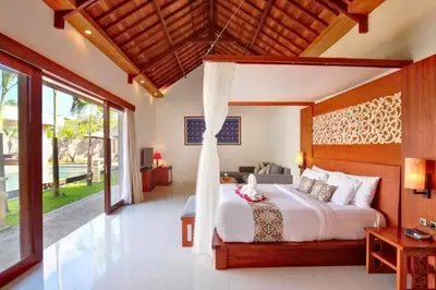 a bedroom with a large bed in a villa at Deanda Elegant 4 BR Private Pool Villa in Jimbaran