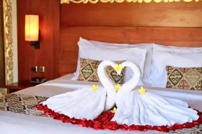 two white swans making a heart on a bed at Deanda Elegant 4 BR Private Pool Villa in Jimbaran