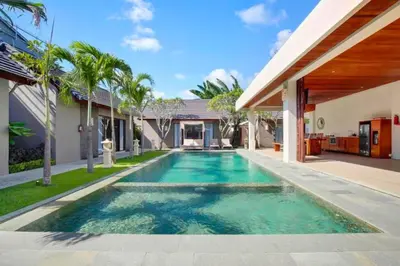 a swimming pool in the backyard of a house at Deanda Elegant 4 BR Private Pool Villa in Jimbaran