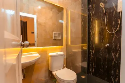 a bathroom with a toilet and a sink and a shower at Mycapsule Bali in Seminyak