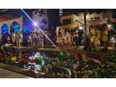 a group of people in a swimming pool at a party at Mycapsule Bali in Seminyak