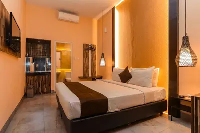 a bedroom with a large bed in a room at Mycapsule Bali in Seminyak