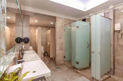 a bathroom with two sinks and a shower at Mycapsule Bali in Seminyak