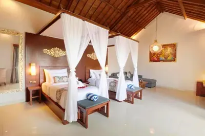 a bedroom with two beds in a room at Eksha Comfortable 3 BR Private Pool Villa in Jimbaran