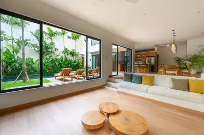 a living room with a couch and a table at Spacious 4BR Family Pool Villa in Sanur