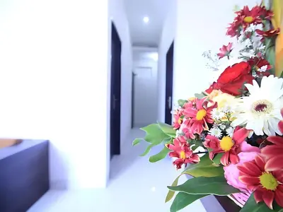 a bouquet of flowers sitting on a table at Wisp Sunset in Legian