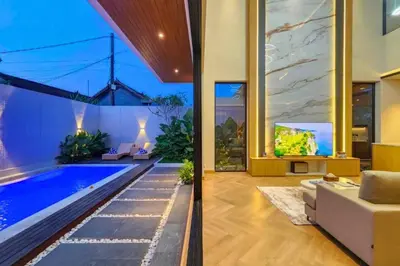 a living room with a swimming pool in a house at Foujina Elegant 4 BR Private Pool Villa in Jimbaran