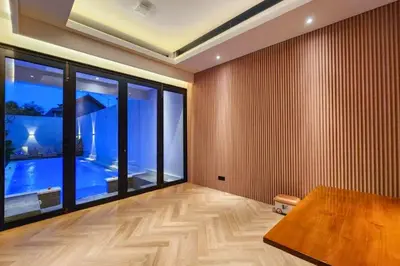 a room with a table and a large window at Foujina Elegant 4 BR Private Pool Villa in Jimbaran
