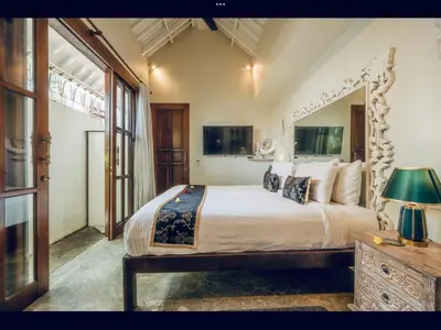 a bedroom with a large bed and a large window at Romantic getaway Seminyak in Seminyak
