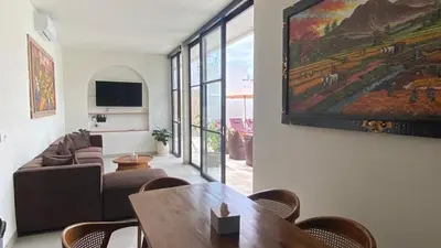 a living room with a large painting on the wall at Narayuka private villa in Seminyak