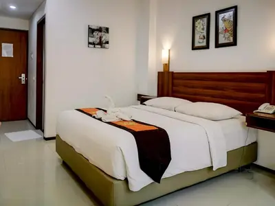 a bedroom with a large bed in a room at Dlima Hotel Villa in Legian