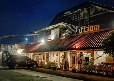 a van parked in front of a building at night at Dlima Hotel Villa in Legian