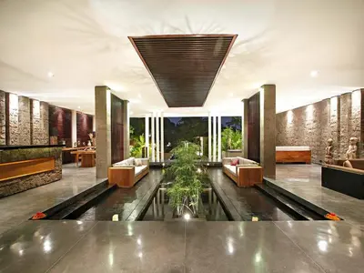 a living room with a pond in the middle at Villa Mona in Canggu
