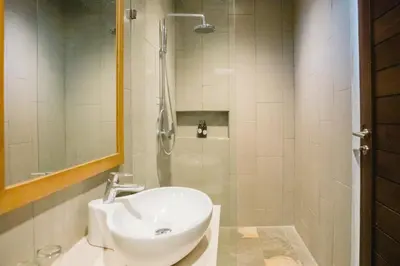 a bathroom with a sink and a shower at Grand Kesambi Resort and Villas Seminyak in Seminyak