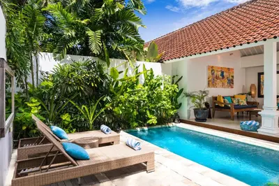 a villa with a swimming pool and a villa at Villa Atma 2BR Fully Equipped Kitchen in Seminyak