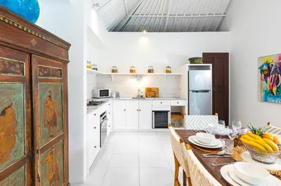 a kitchen with a table with plates on it at Villa Atma 2BR Fully Equipped Kitchen in Seminyak