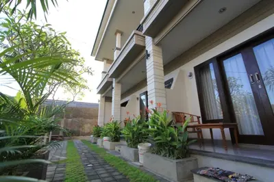 a house with plants on the side of it at De Dukuh Guest House in Kuta
