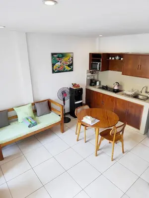 a kitchen with a couch and a table in a room at Villa Sammy in Seminyak
