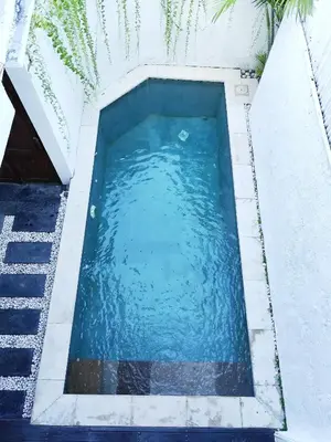 an overhead view of a swimming pool with blue water at Villa Sammy in Seminyak