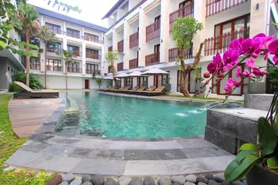 a swimming pool in the middle of a building at Grand La Walon Hotel in Legian