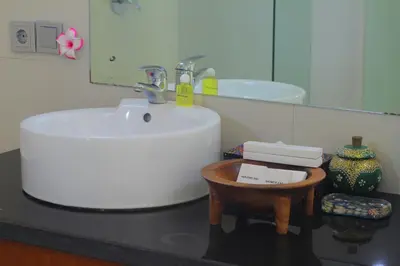 a bathroom with a sink and a mirror at Benoa Rose Residence One in Nusa Dua