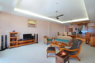 a living room with a couch and a television at Benoa Rose Residence One in Nusa Dua