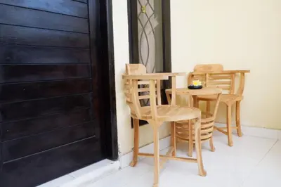 a table and chairs sitting next to a door at Akatara Stay in Jimbaran