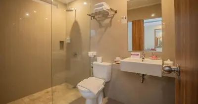 a bathroom with a toilet and a sink and a shower at Swiss-Belinn Seminyak in Seminyak