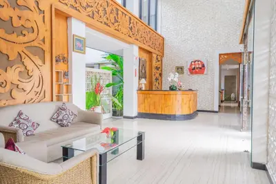 a living room with a couch and a table at Swiss-Belinn Seminyak in Seminyak