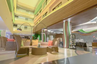 a lobby with couches and chairs in a building at Infinity8 Bali in Jimbaran